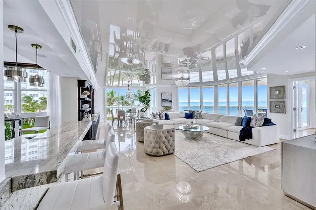 a living room with fireplace furniture and a chandelier