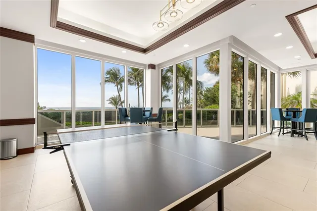 a view of a living room and dining room with a large window
