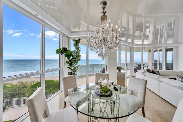 a living room with fireplace furniture and a chandelier