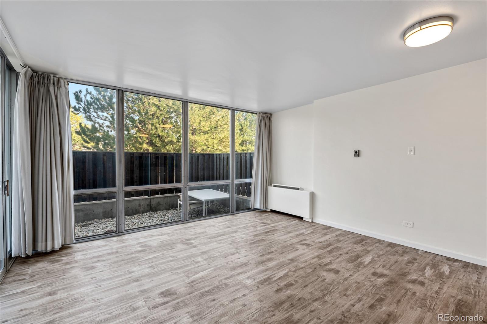 3100 East Cherry Crk N Drive, Unit 108 Denver, CO 80209 - Photo 12 of 25 wooden floor in an empty room with a window
