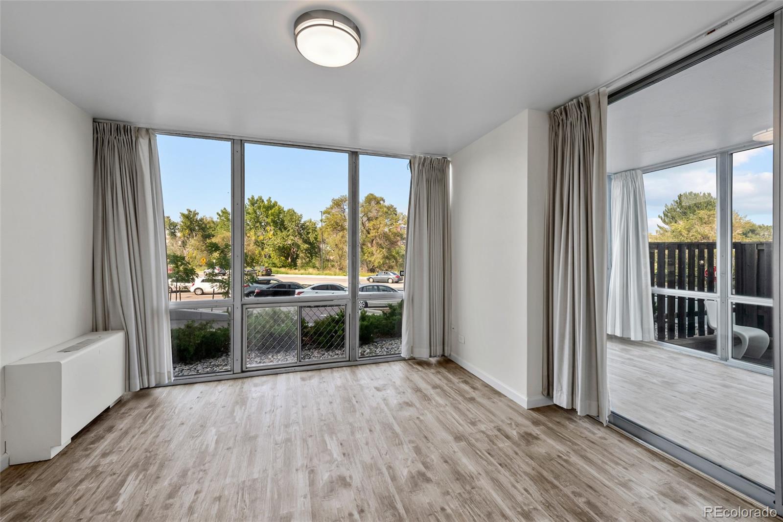 3100 East Cherry Crk N Drive, Unit 108 Denver, CO 80209 - Photo 15 of 25 an empty room with wooden floor and windows