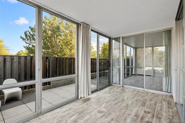 a room with sliding door and wooden floor