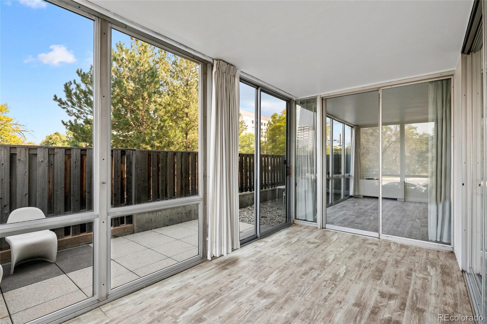 3100 East Cherry Crk N Drive, Unit 108 Denver, CO 80209 - Photo 5 of 25 a room with sliding door and wooden floor