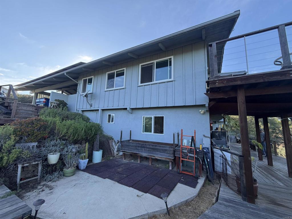 435 Rancho Camino Fallbrook, CA 92028 - Photo 2 of 6 a backyard of a house with wooden floor barbeque oven table and chairs