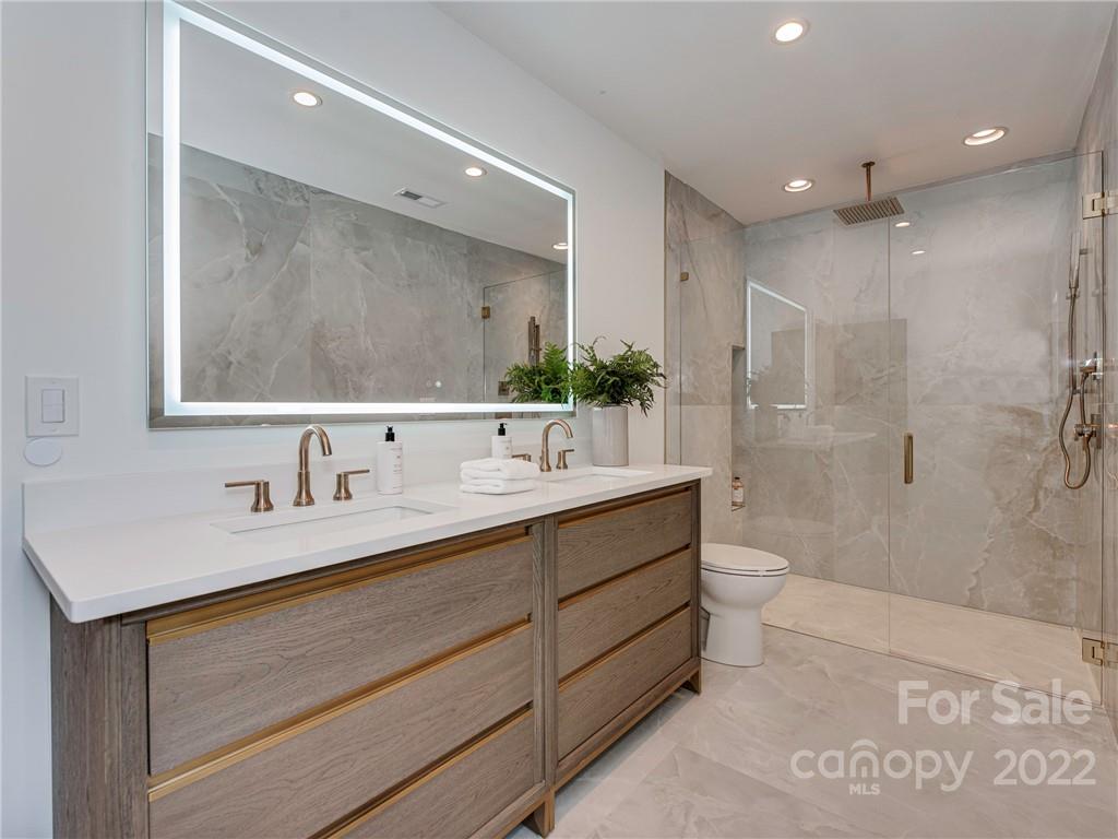 523 Robmont Road Charlotte, NC 28270 - Photo 14 of 26 a bathroom with a sink a toilet and shower