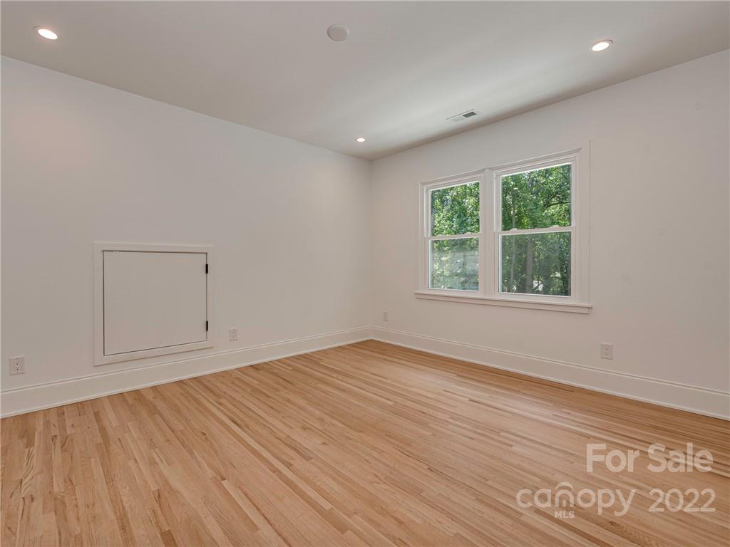 523 Robmont Road Charlotte, NC 28270 - Photo 19 of 26 an empty room with wooden floor and windows