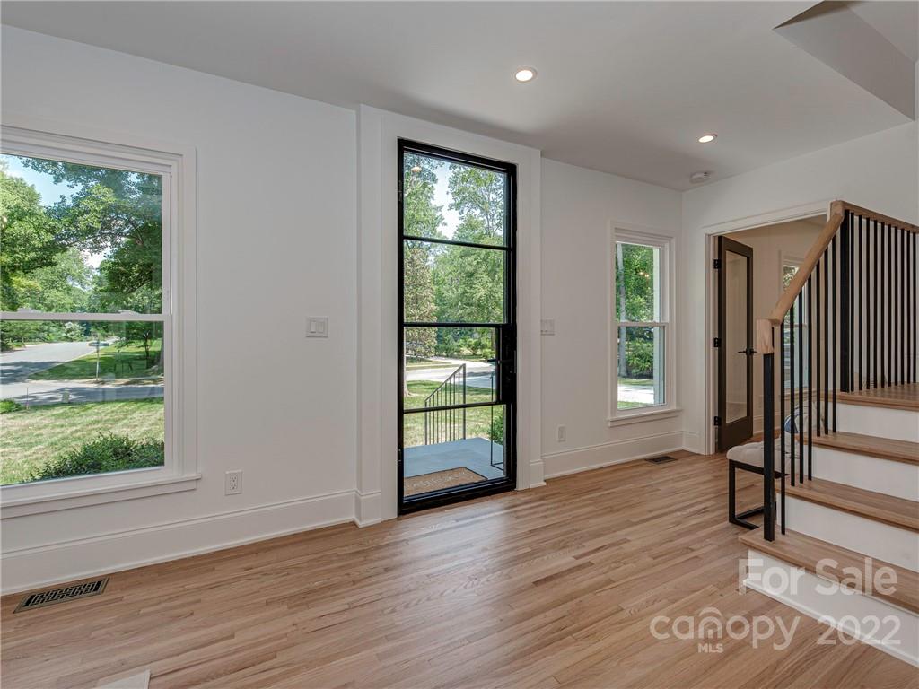 523 Robmont Road Charlotte, NC 28270 - Photo 2 of 26 an empty room with wooden floor and windows