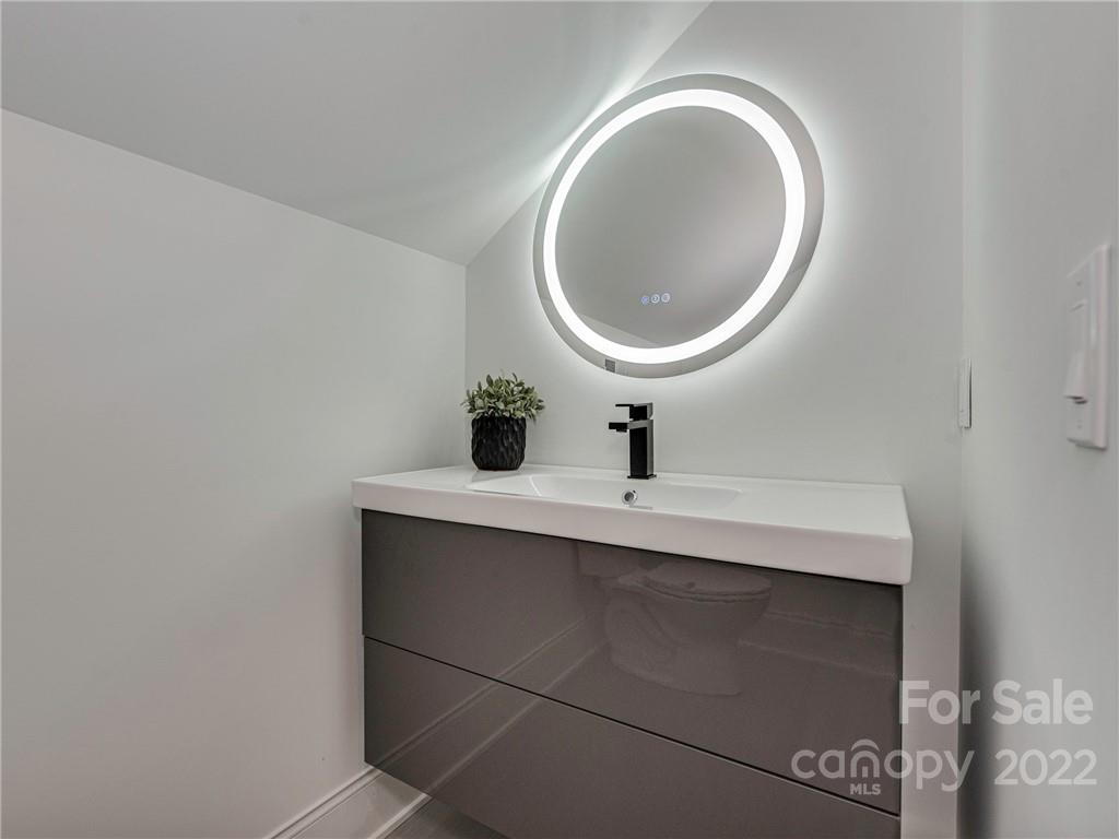 523 Robmont Road Charlotte, NC 28270 - Photo 23 of 26 a bathroom with a sink and a mirror