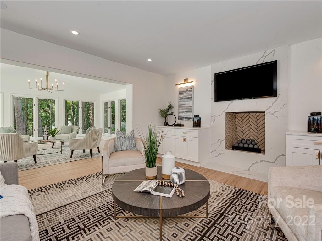 523 Robmont Road Charlotte, NC 28270 - Photo 5 of 26 a living room with furniture a flat screen tv and a fireplace