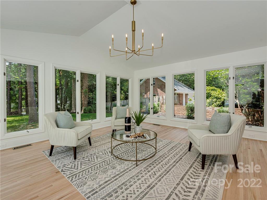 523 Robmont Road Charlotte, NC 28270 - Photo 7 of 26 a living room with patio bathtub and a chandelier