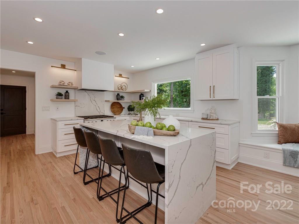 523 Robmont Road Charlotte, NC 28270 - Photo 8 of 26 a kitchen with stainless steel appliances a table and chairs in it