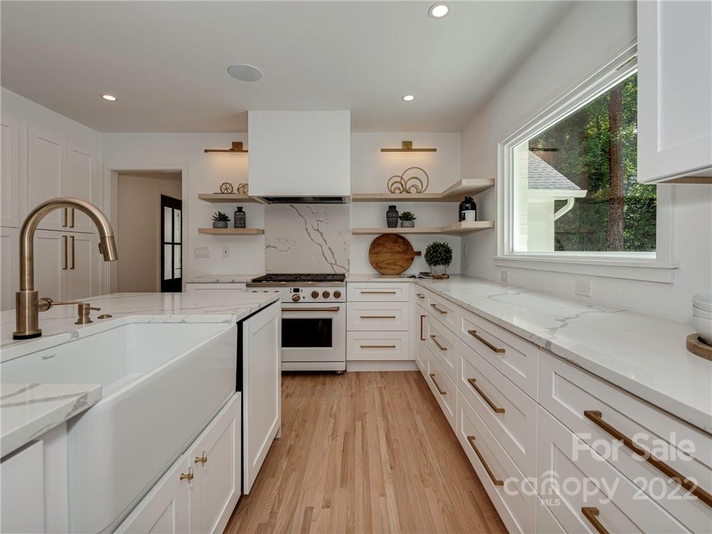 523 Robmont Road Charlotte, NC 28270 - Photo 9 of 26 a kitchen with a stove a sink and a refrigerator
