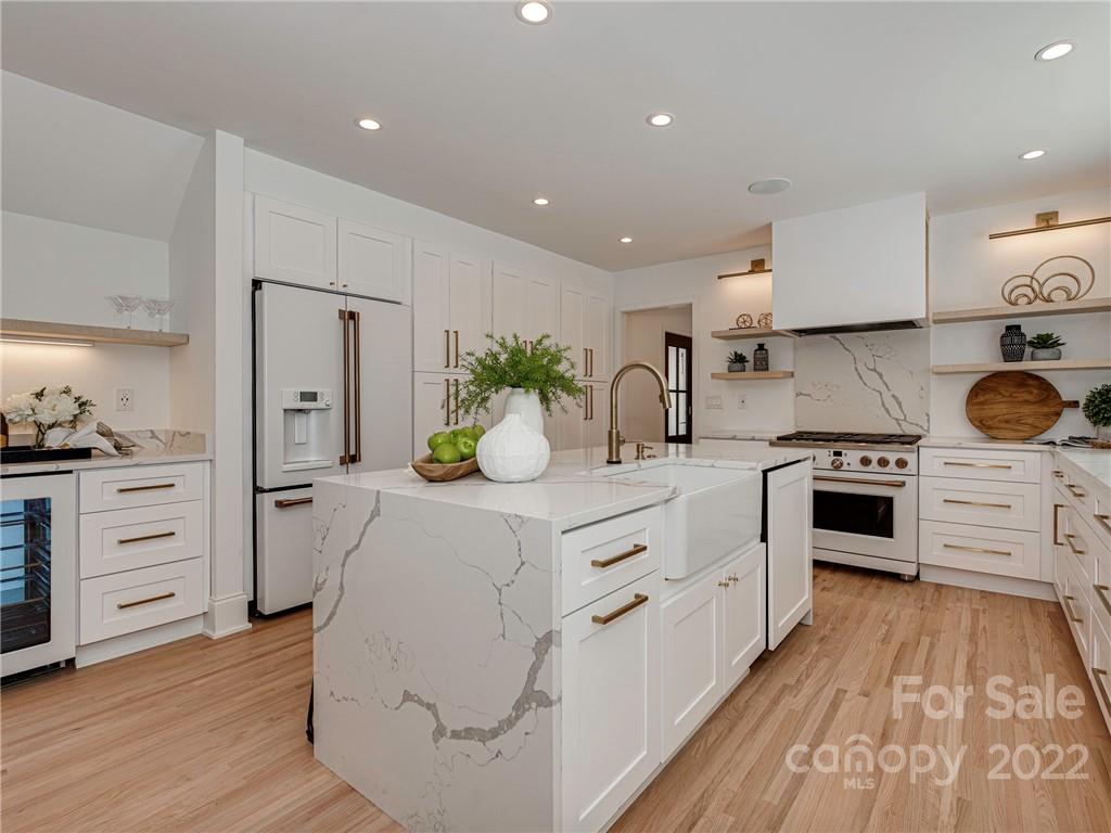 523 Robmont Road Charlotte, NC 28270 - Photo 10 of 26 a kitchen with white cabinets and stainless steel appliances