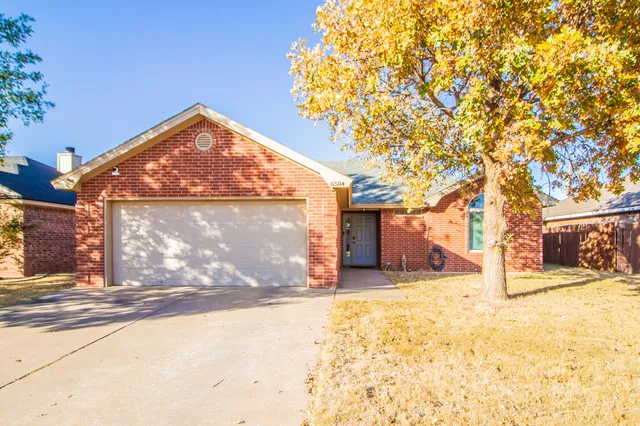 a view of a house with snow next to a road