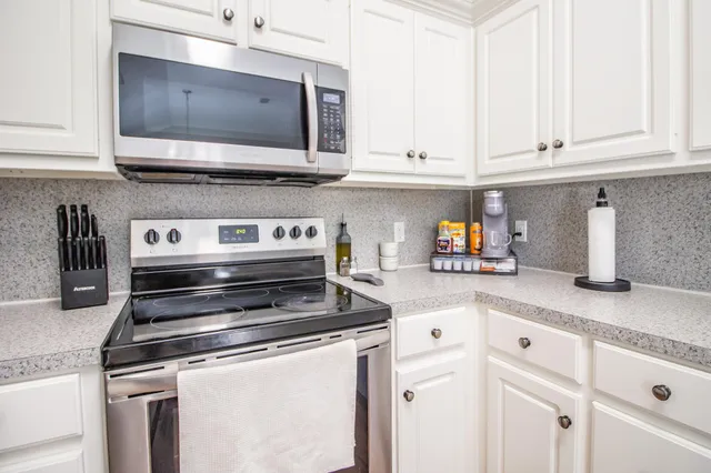 a kitchen with appliances and cabinets