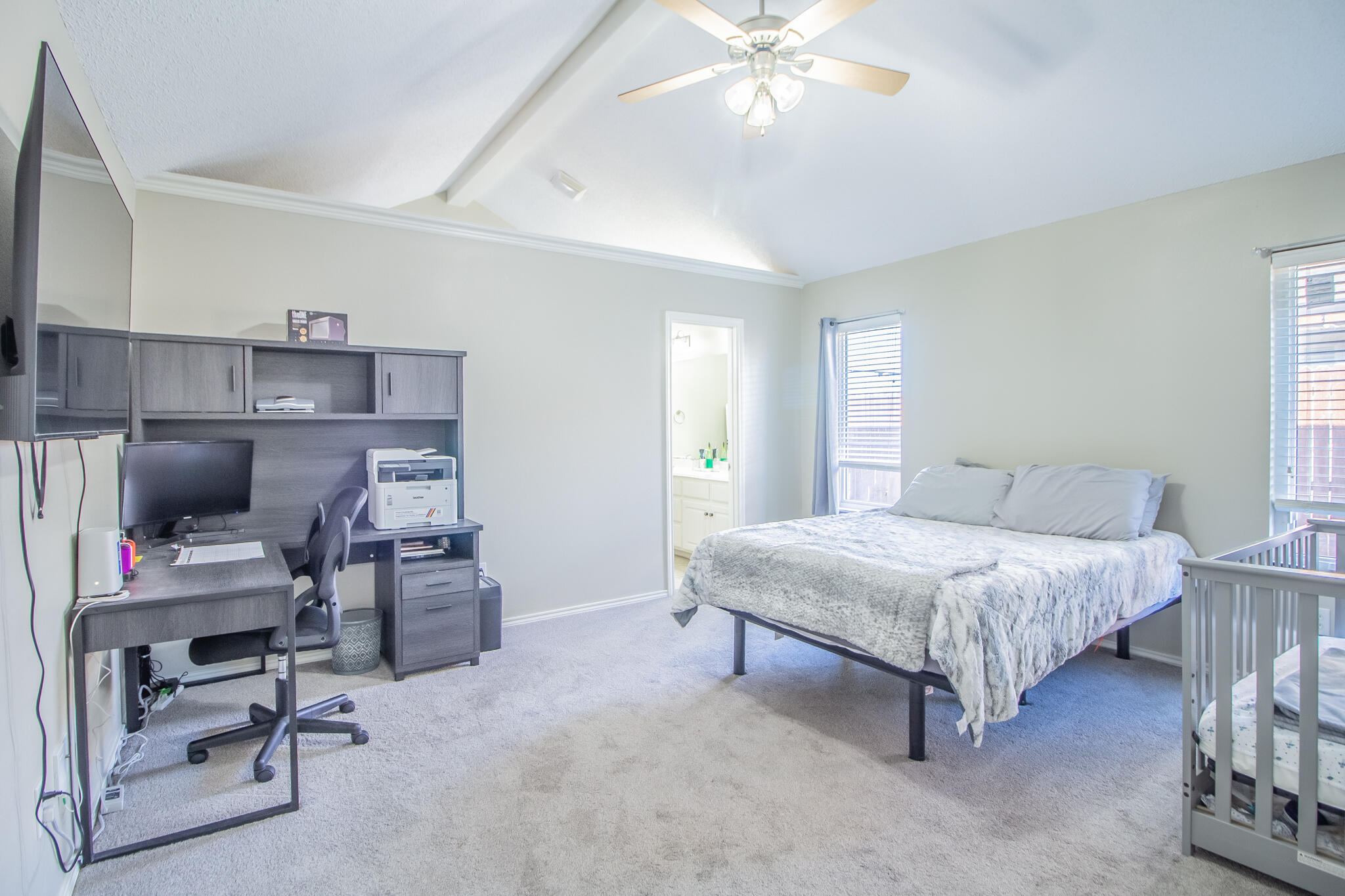 6504 91st Street Lubbock, TX 79424 - Photo 12 of 23 a bedroom with a bed a desk and chair