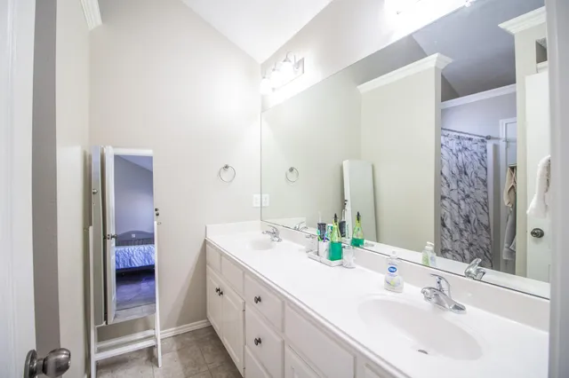 a bathroom with a double vanity sink and a mirror