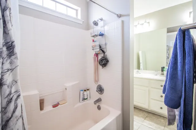 a bathroom with a tub a sink and a shower