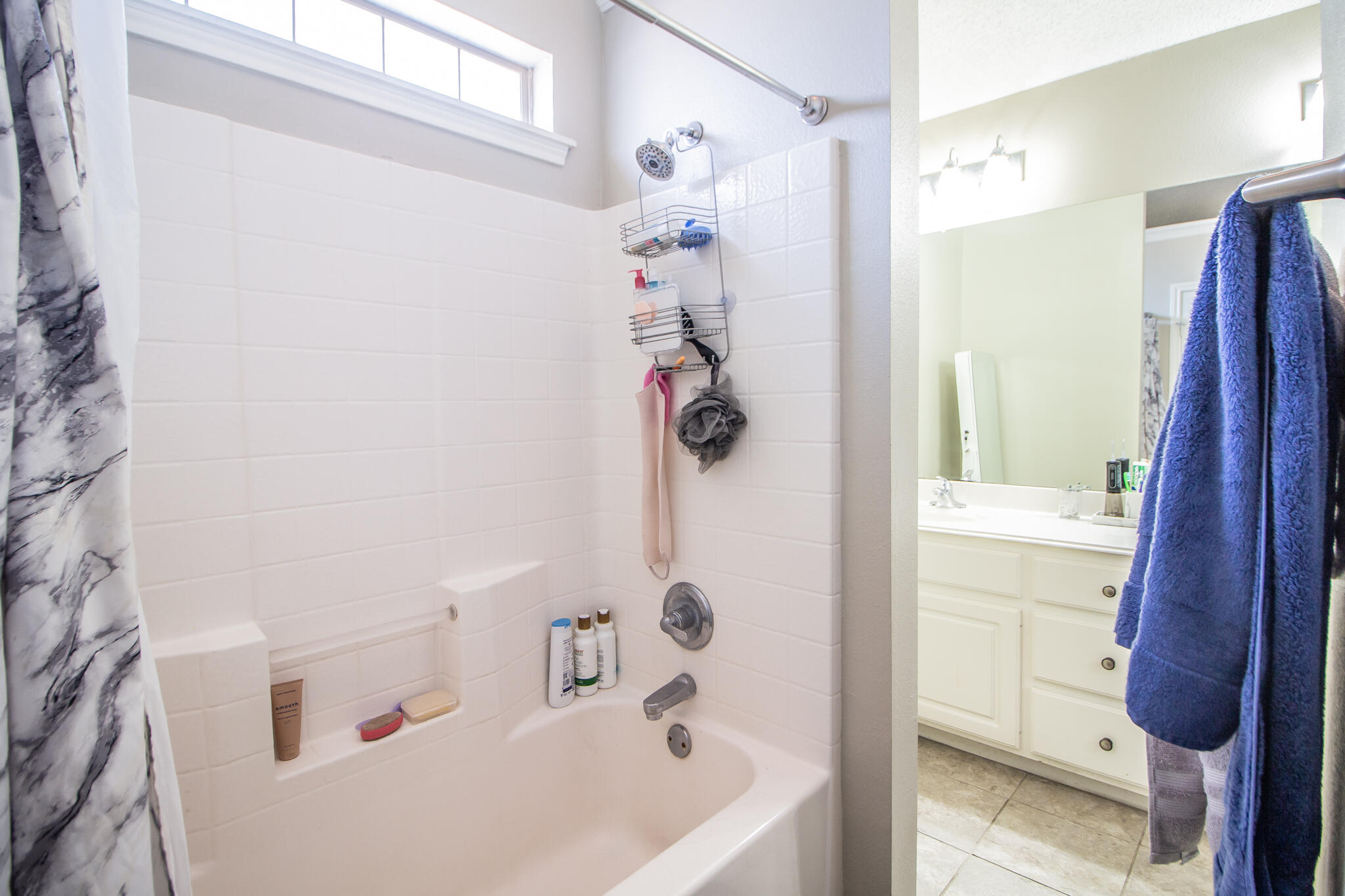 6504 91st Street Lubbock, TX 79424 - Photo 14 of 23 a bathroom with a tub a sink and a shower