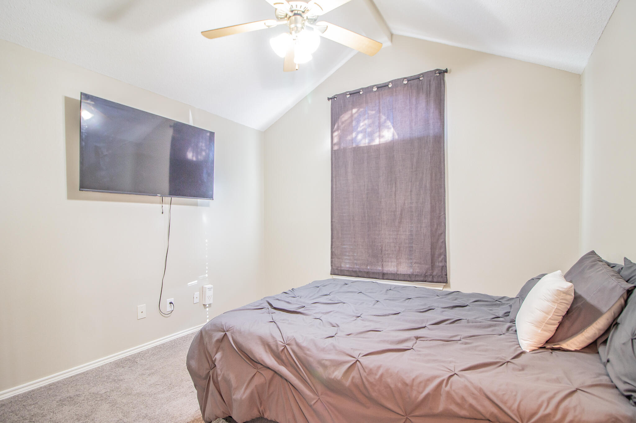 6504 91st Street Lubbock, TX 79424 - Photo 16 of 23 a bedroom with a bed and a chandelier