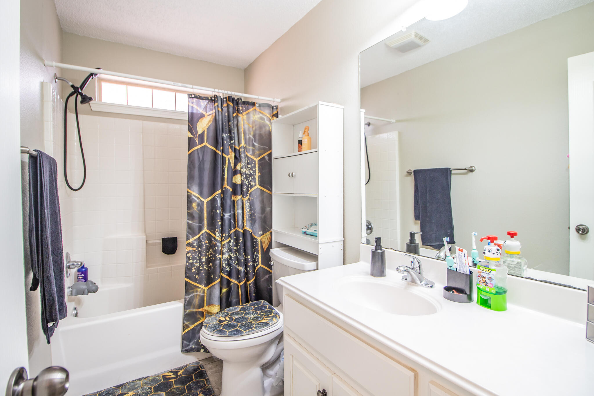 6504 91st Street Lubbock, TX 79424 - Photo 17 of 23 a bathroom with a sink a toilet and shower