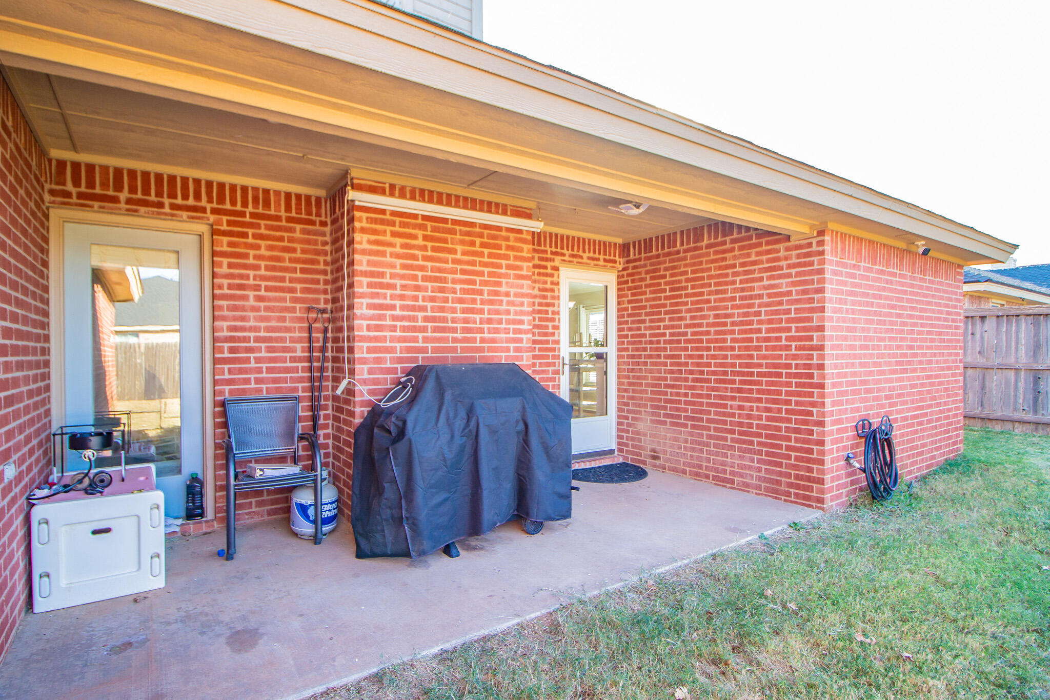 6504 91st Street Lubbock, TX 79424 - Photo 21 of 23 a view of a backyard with furniture and a porch