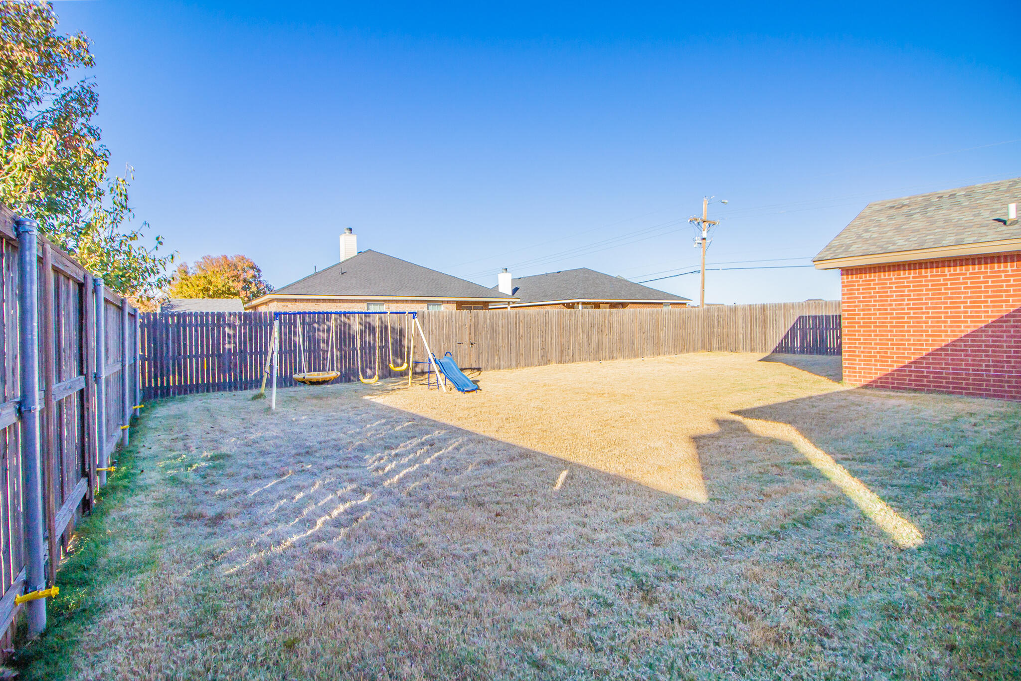 6504 91st Street Lubbock, TX 79424 - Photo 22 of 23 a view of a house with backyard and tree