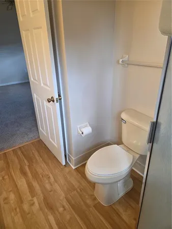 a bathroom with a toilet and a shower
