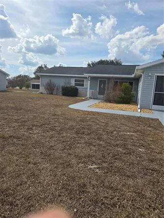 a front view of house with yard and car parked