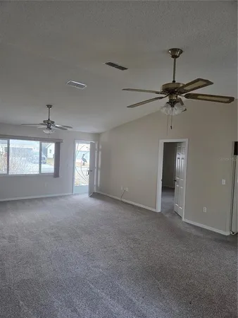 a view of a room with a ceiling fan