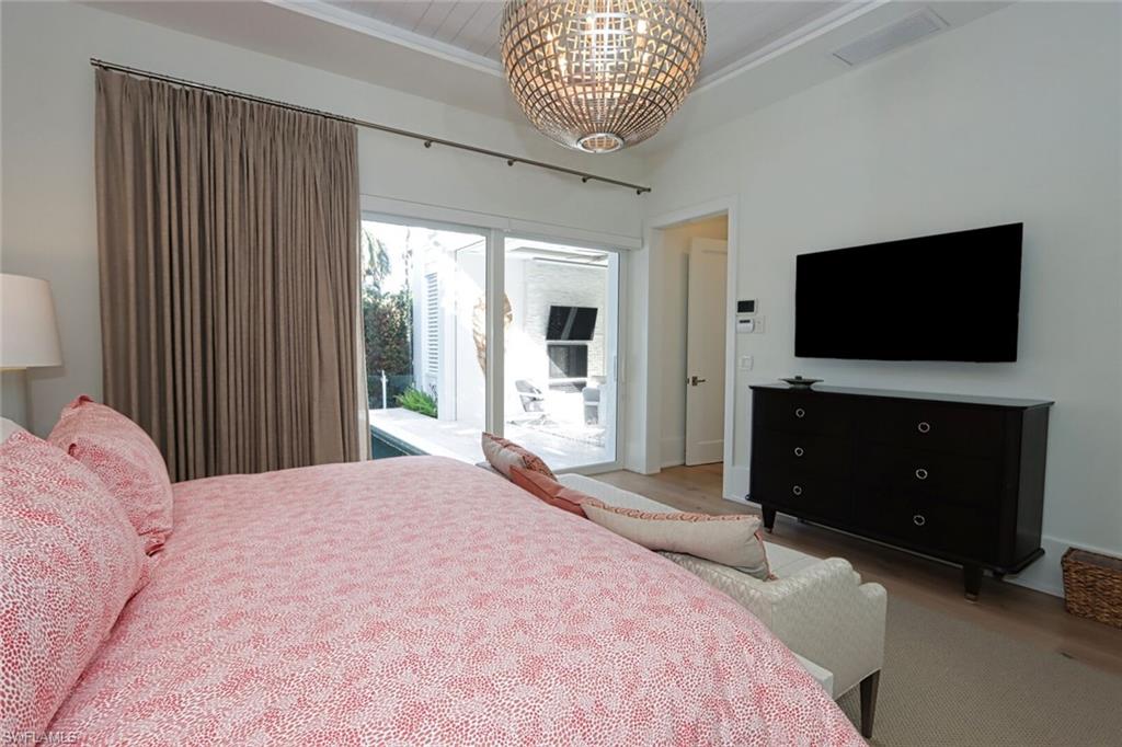 675 2nd Street South Naples, FL 34102 - Photo 27 of 41 a bedroom with a bed and a flat screen tv