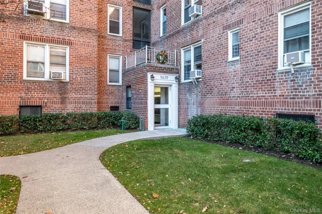 a view of a brick building next to a yard
