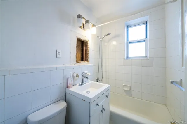 a bathroom with a sink a toilet and bathtub