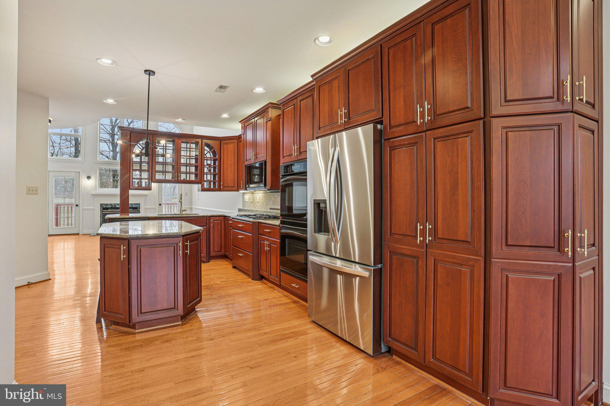82 Granville Way Exton, PA 19341 - Photo 15 of 51 a kitchen with stainless steel appliances granite countertop a refrigerator a sink dishwasher a stove and a wooden cabinets