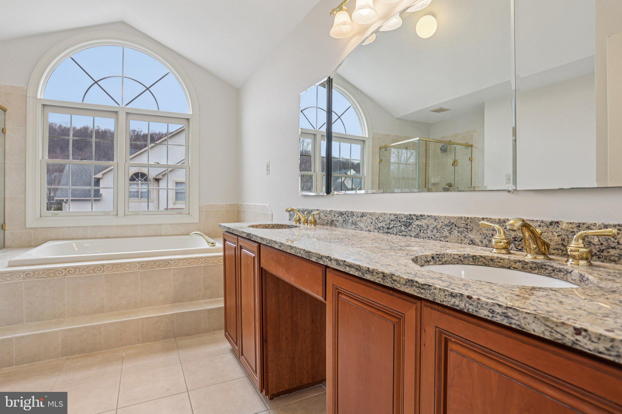 82 Granville Way Exton, PA 19341 - Photo 40 of 51 a bathroom with a granite countertop double vanity sink and a bathtub