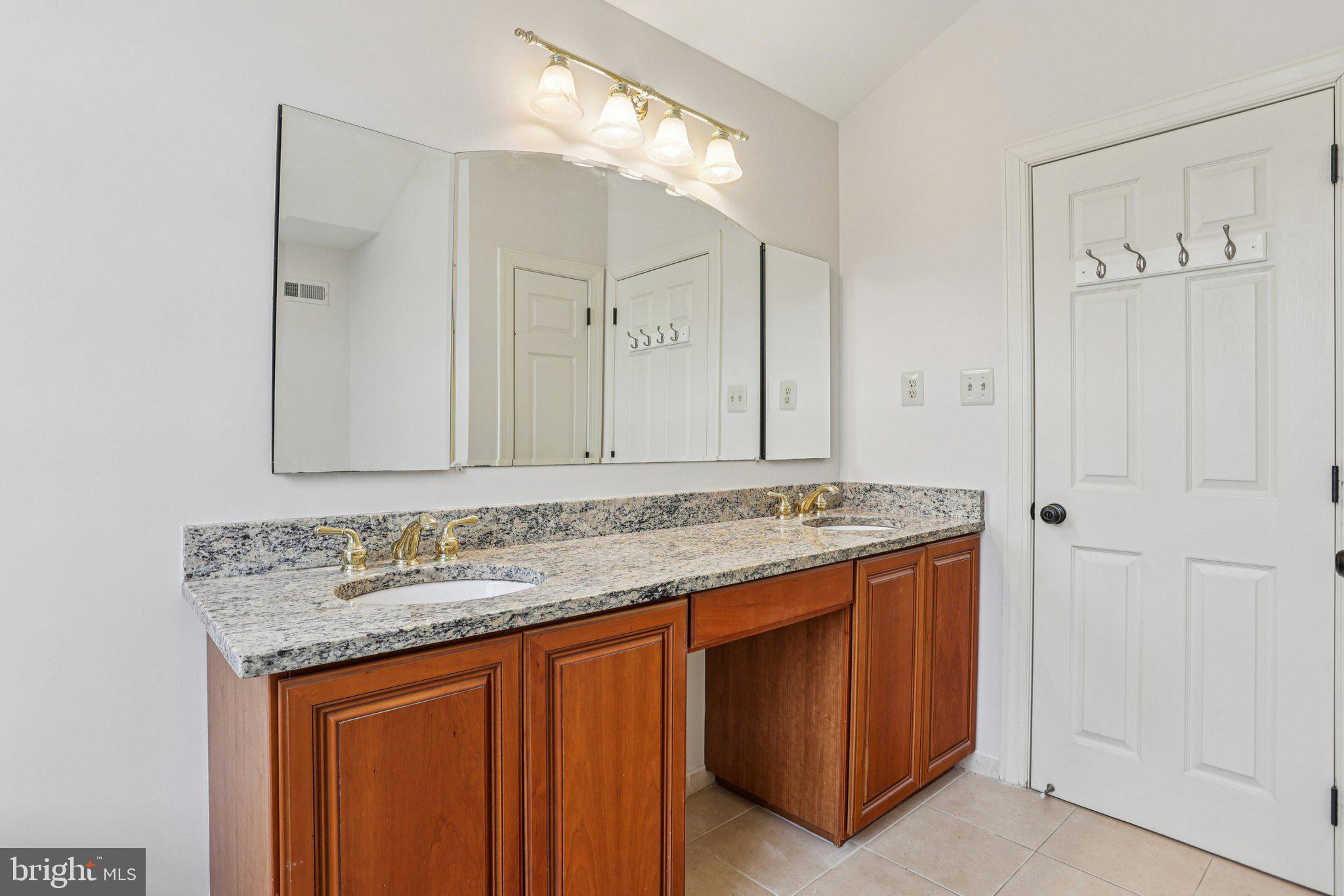 82 Granville Way Exton, PA 19341 - Photo 42 of 51 a bathroom with a granite countertop sink and a mirror