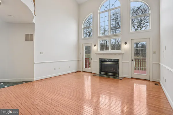 a view of an empty room with chandelier