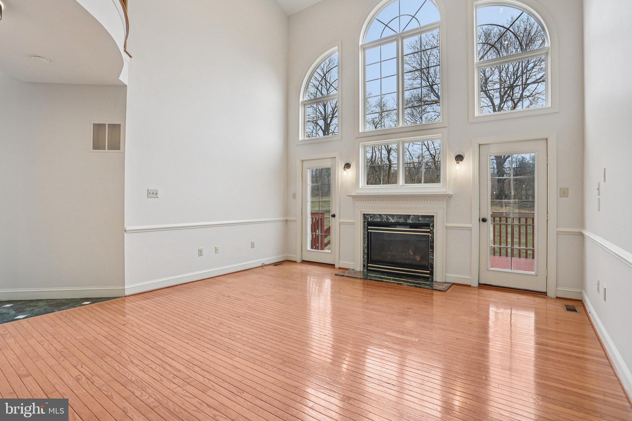 82 Granville Way Exton, PA 19341 - Photo 5 of 51 a view of an empty room with wooden floor fireplace and a window