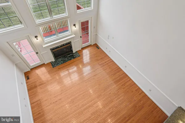 a kitchen with stainless steel appliances granite countertop hardwood cabinets and wooden floor
