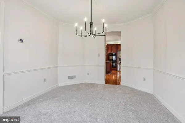 a kitchen with stainless steel appliances granite countertop a refrigerator a sink dishwasher a stove and a wooden cabinets