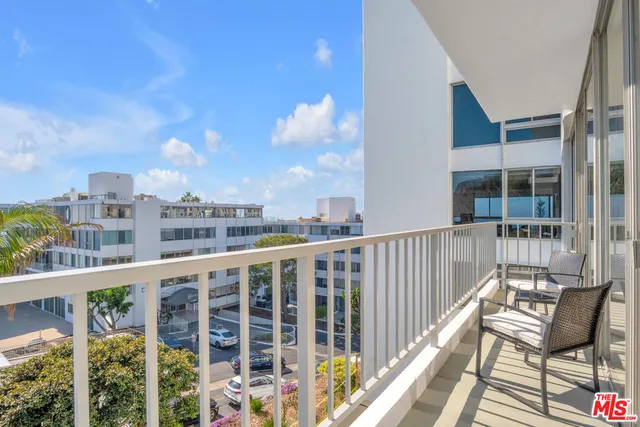 a view of a chairs and table in the balcony