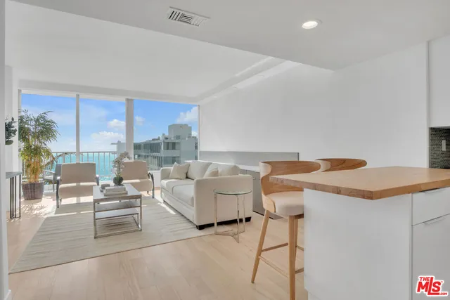 a living room with fireplace furniture and a large window
