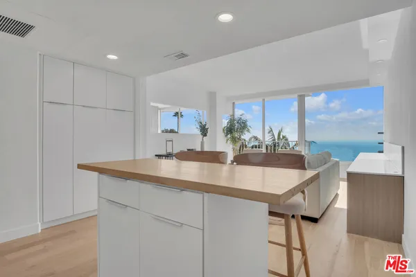 a kitchen with stainless steel appliances granite countertop a sink and a refrigerator