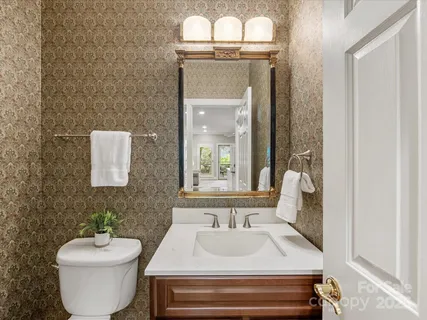 a kitchen with granite countertop a sink cabinets and wooden floor