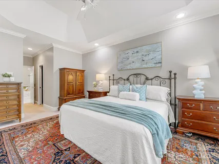 a kitchen with white cabinets and sink