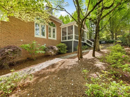 a front view of a house with a yard and potted plants