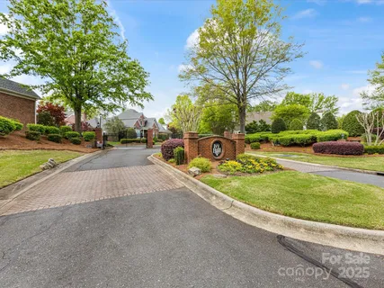 a view of a dining room with furniture a chandelier and wooden floor