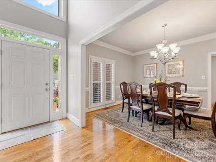 a living room with furniture fireplace and large windows
