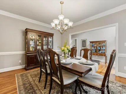 a living room with furniture fireplace and a large window