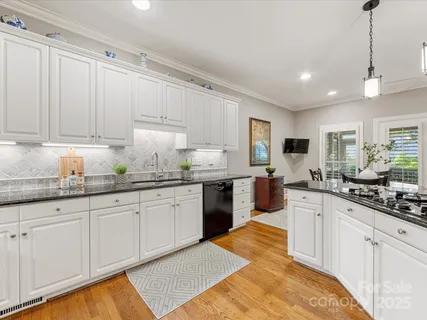 a dining room with stainless steel appliances kitchen island a table and chairs